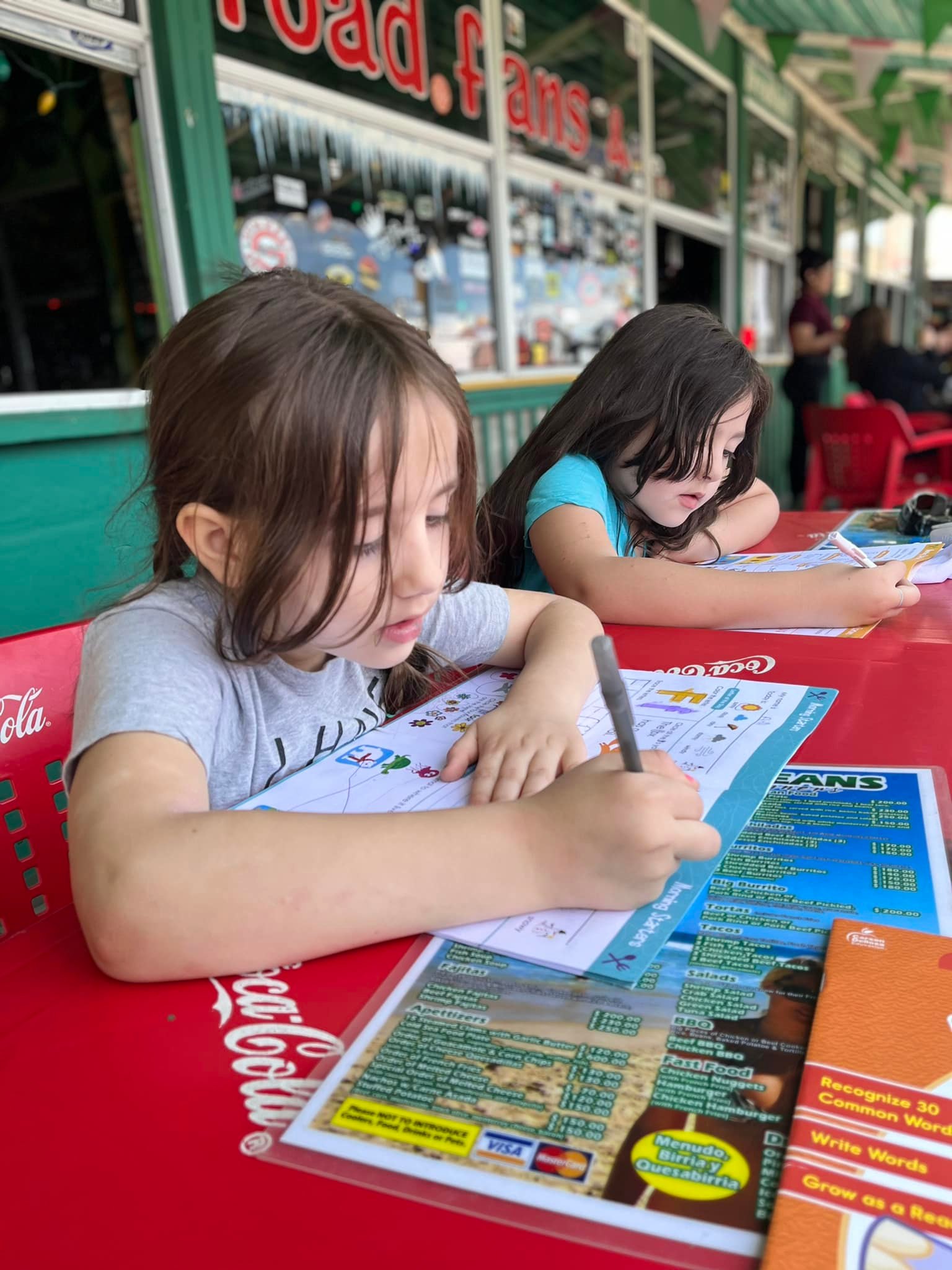 Woman writing about healing from grief and emotional burnout after death of husband. (Pictured: daughters of late husband homeschooling on trip)